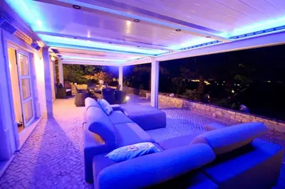 a living room with blue lights and a couch at Casa Grayson in Loulé