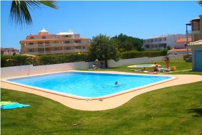 a large swimming pool in the middle of a yard at Akisol Albufeira Aqua II in Albufeira