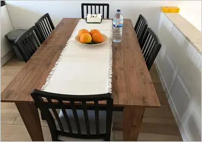 a wooden table with a bowl of oranges and a bottle of water at Windmill Hill - Alto do Moinho - Pool & Sea View in Albufeira