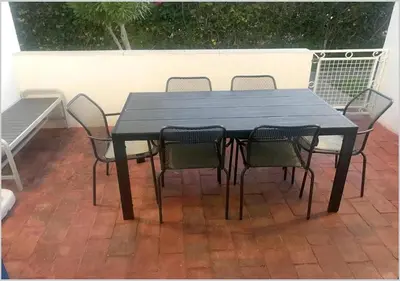 a black table and chairs on a patio at Windmill Hill - Alto do Moinho - Pool & Sea View in Albufeira