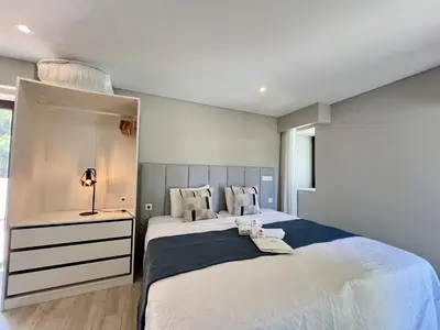 a bedroom with two beds and a mirror at Vilamoura Premium Villa With Pool by Homing in Vilamoura