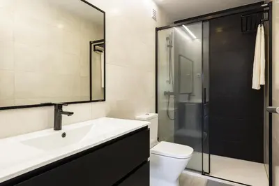 a bathroom with a sink and a toilet and a shower at SeaVillage Asia - City Center by HD in Vilamoura