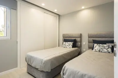 a bedroom with two beds and a window at SeaVillage Asia - City Center by HD in Vilamoura