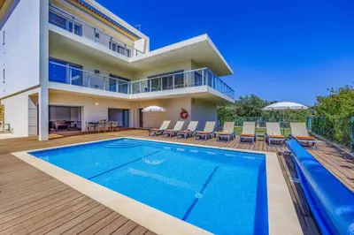 a villa with a swimming pool and a house at Villa Casa Joao by Villa Plus in Albufeira