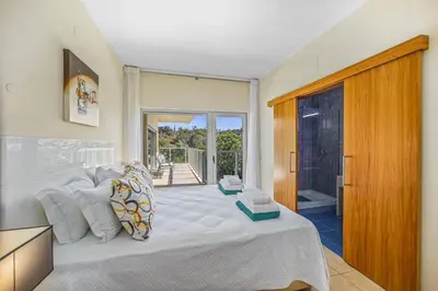 a bedroom with a large bed and a balcony at Villa Casa Petunia by Villa Plus in Albufeira