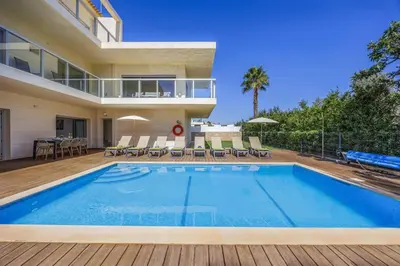 a swimming pool in the backyard of a house at Villa Casa Petunia by Villa Plus in Albufeira