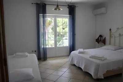 a bedroom with two beds and a large window at Villa com piscinas - Quintinha do Lago in Quarteira
