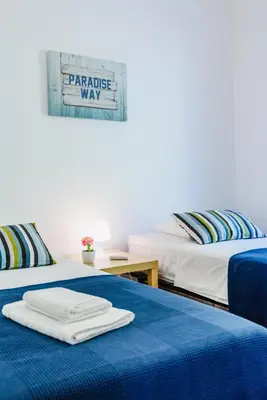 a bedroom with two beds and two windows at Villa 715 - our Albufeira holiday retreat in Albufeira