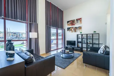 a living room with two couches and a large window at Villa Malibu Marina in Albufeira