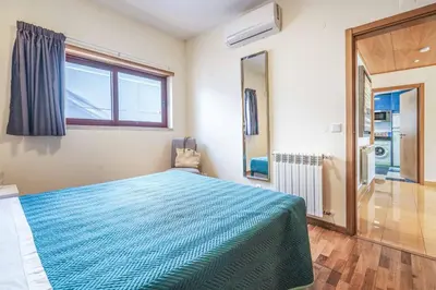 a bedroom with a blue bed and a window at Villa Malibu Marina in Albufeira