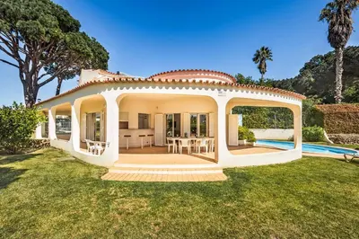 a white bathroom with a sink and a shower at Casa Paraiso in Vilamoura