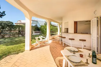 a large kitchen with wooden cabinets and a sink at Casa Paraiso in Vilamoura