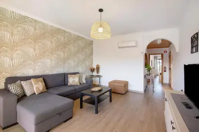 a living room with a couch and a table at Cosy Apartment With Pool 2 in Vilamoura
