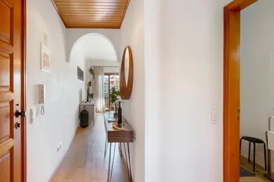a hallway with white walls and a wooden ceiling at Cosy Apartment With Pool 2 in Vilamoura