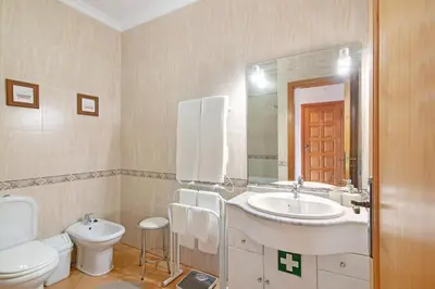 a bathroom with a sink and a toilet and a mirror at Cosy Apartment with Pool 1 in Vilamoura