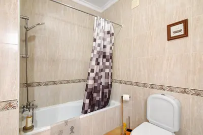 a bathroom with a toilet and a bath tub at Cosy Apartment with Pool 1 in Vilamoura