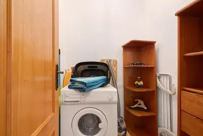 a washing machine in a room with a shelf at Cosy Apartment with Pool 1 in Vilamoura