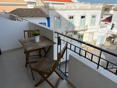 a bedroom with a large bed with two towels on it at Paulos Studio in Faro