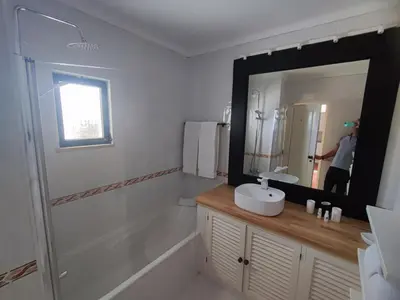 a bathroom with a sink and a large mirror at Albufeira, T1 in Balaia Golf Village, Algarve in Albufeira