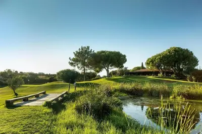 a wooden bridge over a pond in a park at Albufeira, T1 in Balaia Golf Village, Algarve in Albufeira