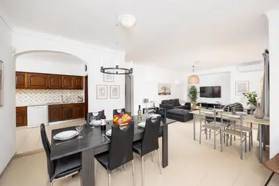 a kitchen and living room with a table and chairs at Villa Baltin in Albufeira