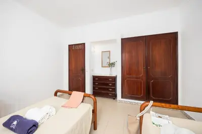 a bedroom with a bed and a dresser in a room at Villa Baltin in Albufeira
