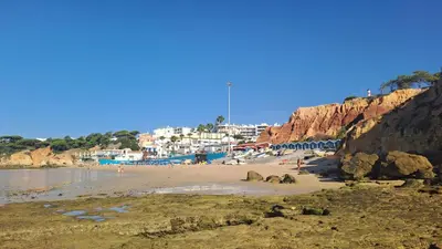 a beach with a bunch of people on it at Praia da Falésia, O Melhor Estúdio da Aldeia das Acoteias in Albufeira