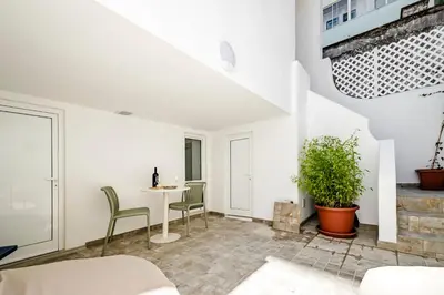 a living room with a table and chairs at Casas das Ilhas in Faro