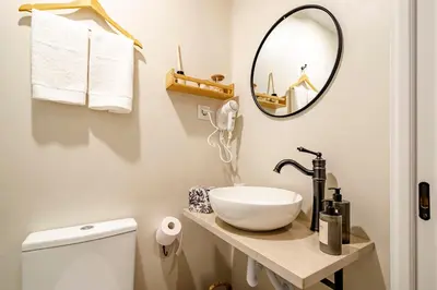a bathroom with a sink and a mirror at Casas das Ilhas in Faro