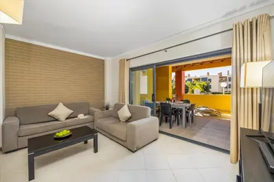 a living room with a couch and a table at Palm Breeze Terrace Vilamoura in Vilamoura
