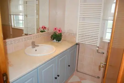 a bathroom with a sink and a mirror at Holiday home in Santa Barbara de Nexe - Algarve 51807 in Santa Bárbara de Nexe