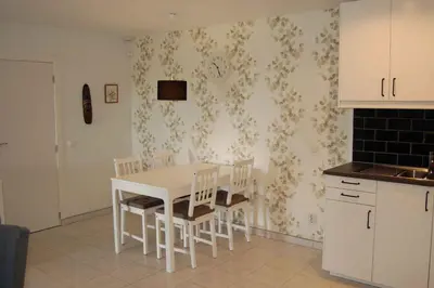 a kitchen with a white table and chairs at Holiday home in Santa Barbara de Nexe - Algarve 51807 in Santa Bárbara de Nexe