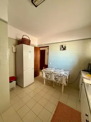 a kitchen with white cabinets and a stove top oven at Espadarte Quarteira Balcony Flat in Quarteira