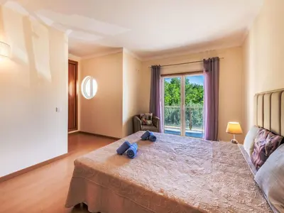 a bedroom with a large bed and a window at Holiday Home Vila Parra by Interhome in Galé