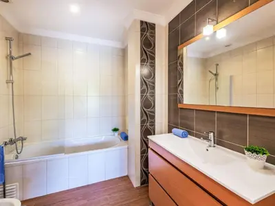 a bathroom with a tub and a sink and a bath tub at Holiday Home Vila Parra by Interhome in Galé