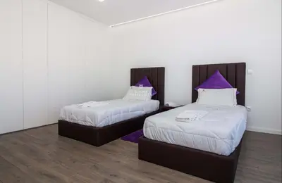 a bedroom with a large bed with a large window at Dalma- Villa da Ourada in Sesmarias