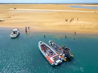 two boats in the water next to a beach at Villa Agadir by Algarve Vacation in Albufeira