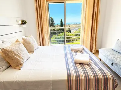 a bedroom with a large bed with a large window at Sea View Apartment by Be Cherish in Albufeira
