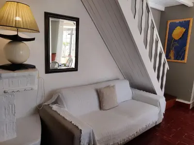 a living room with a white couch and stairs at Quinta dos Amigos in Almancil
