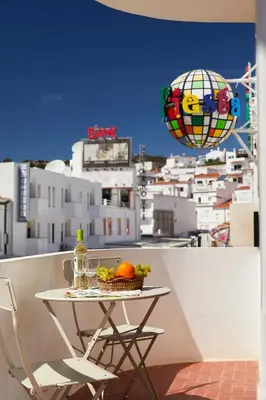 a table with a bowl of fruit and a balloon at Casas Barulho Apartment Old Town in Albufeira