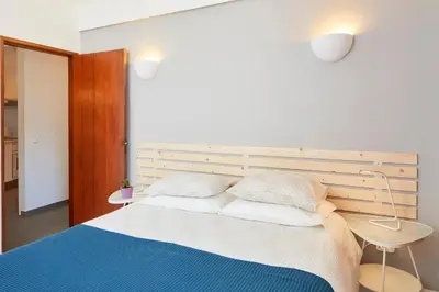a bedroom with a large bed with two pillows at Casas Barulho Apartment Old Town in Albufeira