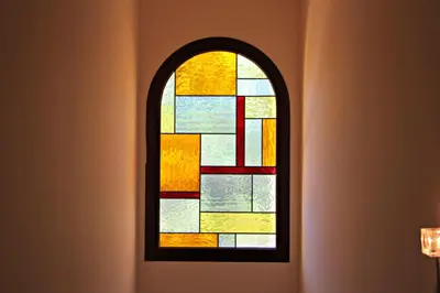 a stained glass window in the corner of a room at Vilamoura Typical 3 With Pool by Homing in Quarteira