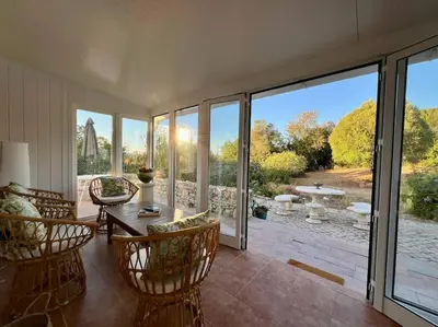 a living room with a table and chairs at Casa de Limoeiro - Countryside Villa in Córregos de Santa Luzia