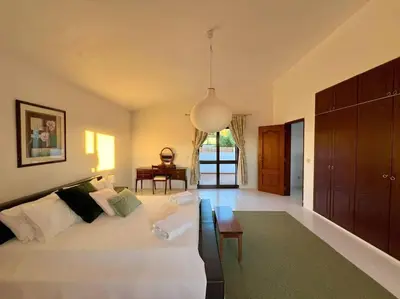 a living room with a white bed and a table at Casa de Limoeiro - Countryside Villa in Córregos de Santa Luzia