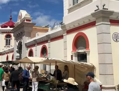 a group of people standing around a market in front of a building at Casa de Limoeiro - Countryside Villa in Córregos de Santa Luzia