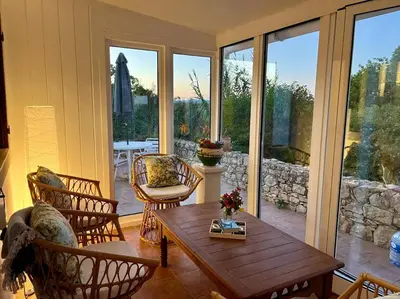 a living room with a wooden table and chairs at Casa de Limoeiro - Countryside Villa in Córregos de Santa Luzia