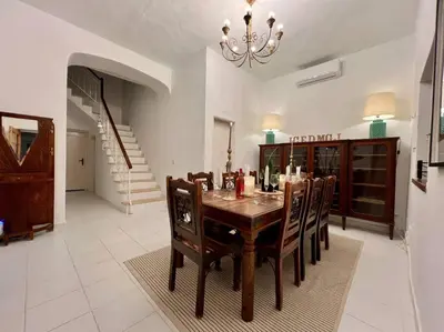 a dining room with a table with chairs and a chandelier at Casa de Limoeiro - Countryside Villa in Córregos de Santa Luzia