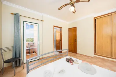 a living room with white furniture and a fireplace at Villa Santa Maria in Albufeira