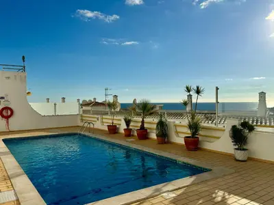a swimming pool on a balcony with a view of the ocean at Fantastic view over the sea in Albufeira