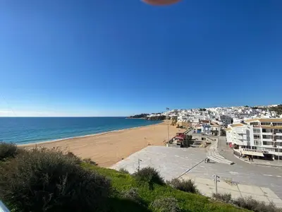 a view of a beach with buildings and the ocean at Fantastic view over the sea in Albufeira